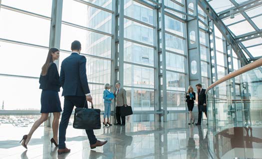 Collegues walking through a multi-story office building
