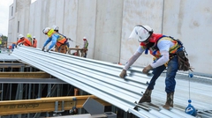 Workers placing dovetail deck on to support beams