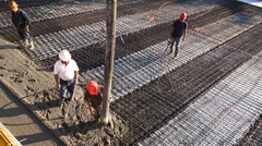 Concrete being poured onto bridge deck and rebar