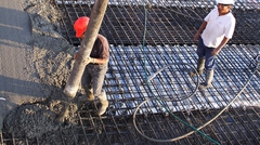 Working guiding flow of concrete onto bridge deck forms