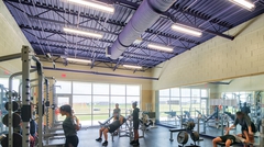 Exercise room with steel joist and deck roof