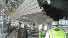 Stadium construction showing workers installing Versa-Dek® dovetail