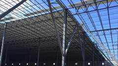 View looking up at steel deck installation on steel joists