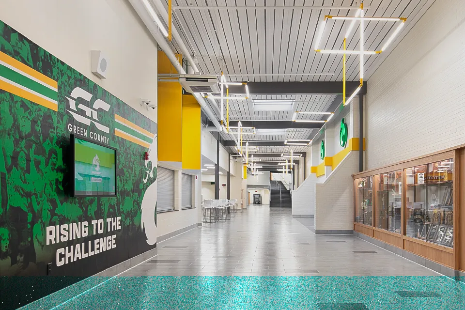 4 Challenging Learning Environments solved by Steel. Hallway of school with acoustic deck.